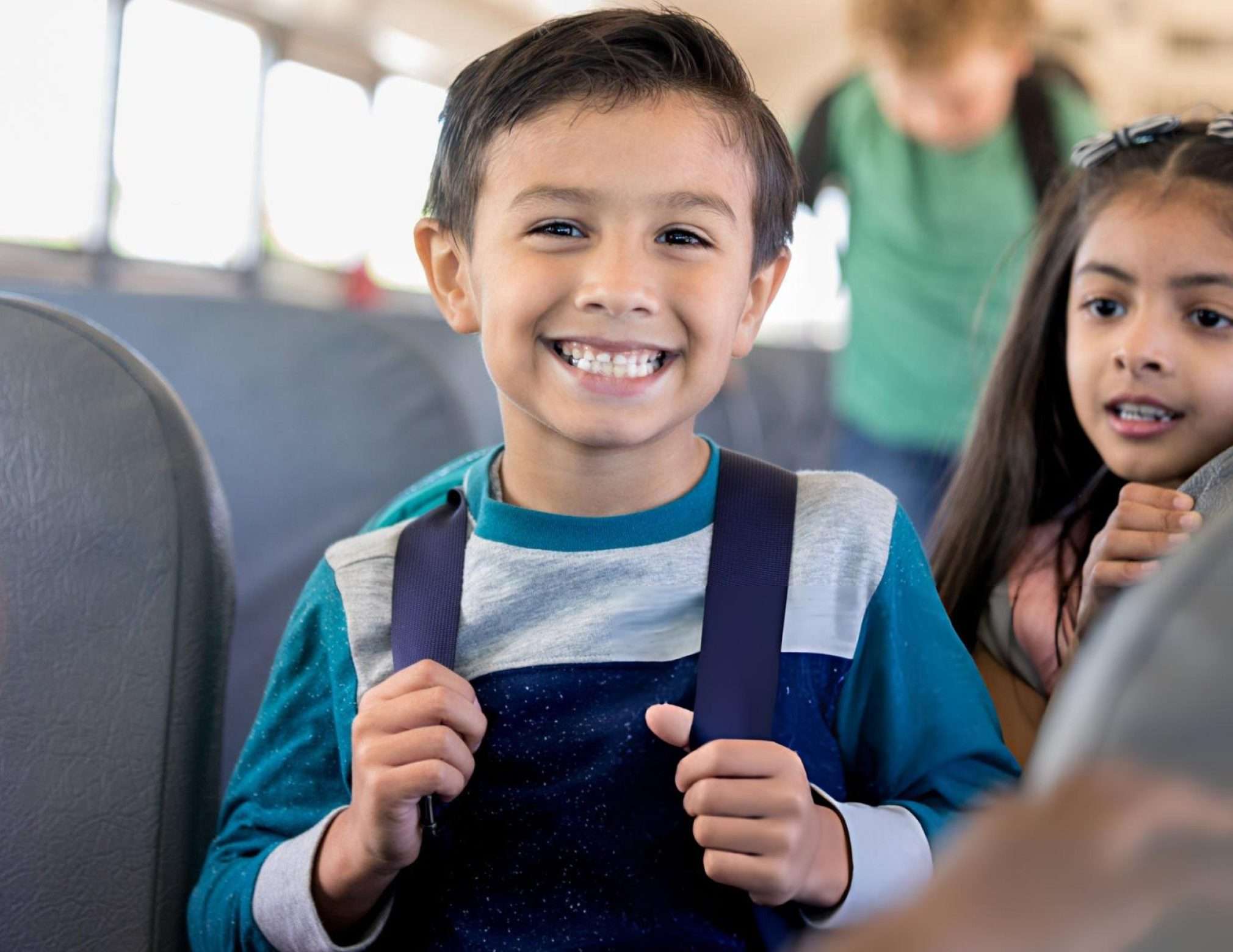 Boy on a school bus smiling