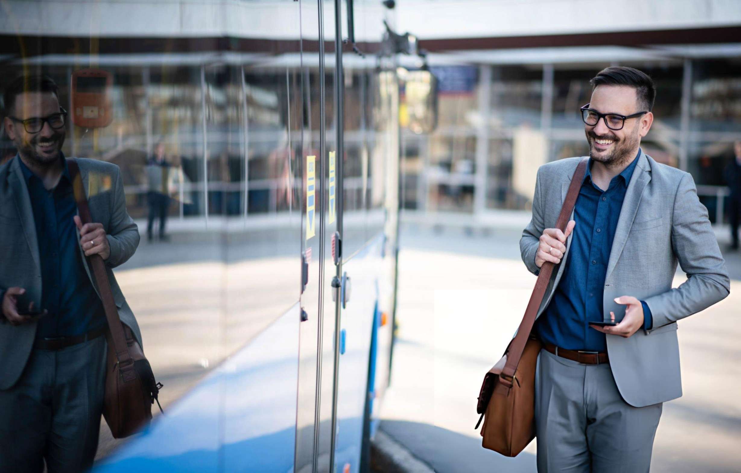 happy employee in front of the company bus